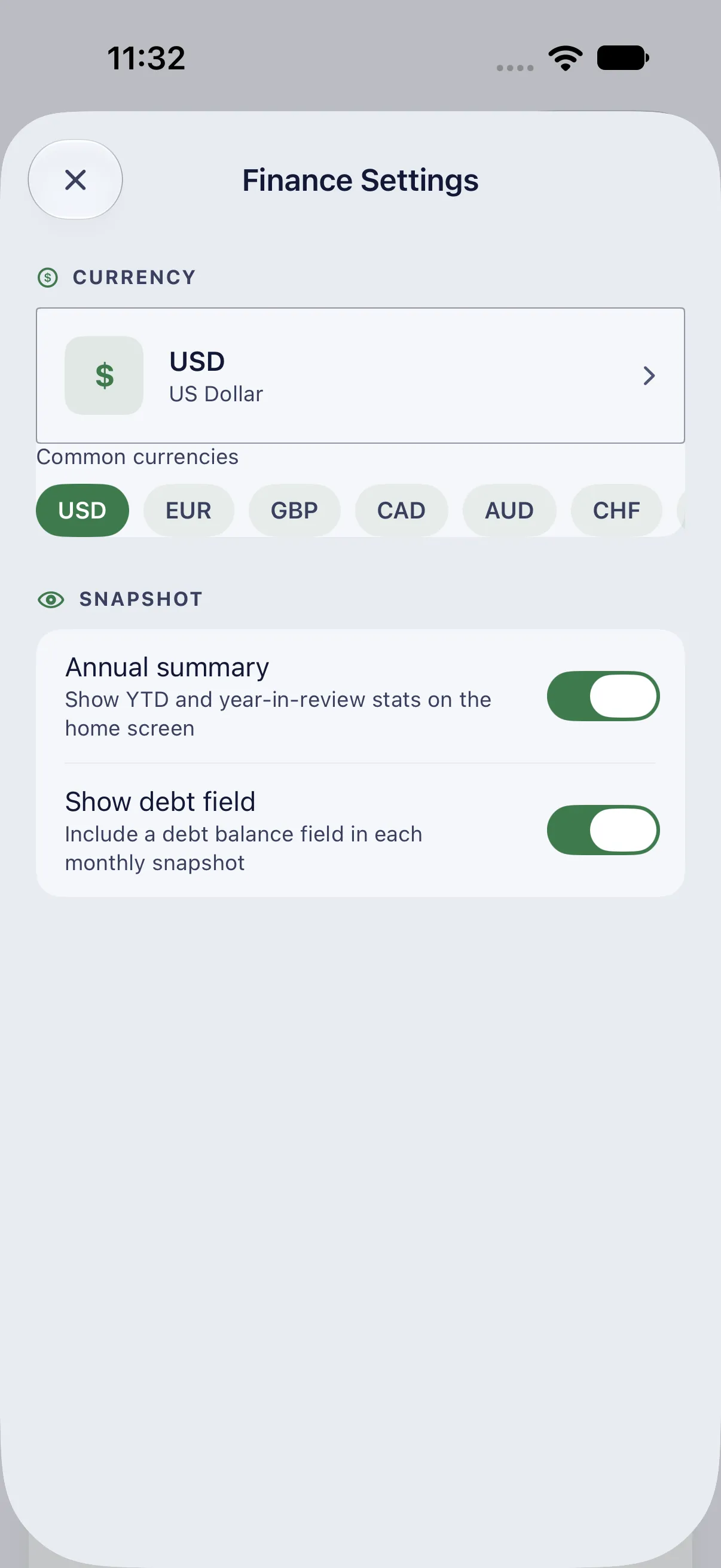 HourLife Finances: The currency, here USD, with “Annual summary” and “Show debt field” both on.